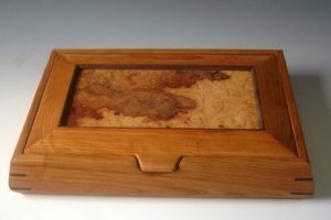 Decorative wooden box made of cherry wood with a beautiful patterned maple burl piece for the lid
