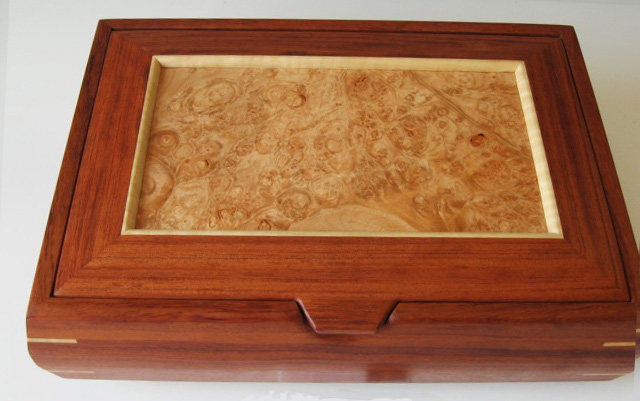 A handmade decorative box made of bubinga wood from Africa and a maple burl lid
