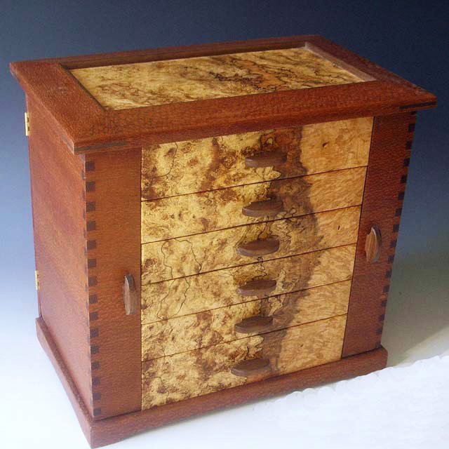 This fashion jewelry box is designed to hold all jewelry plus hanging necklaces in the side doors.