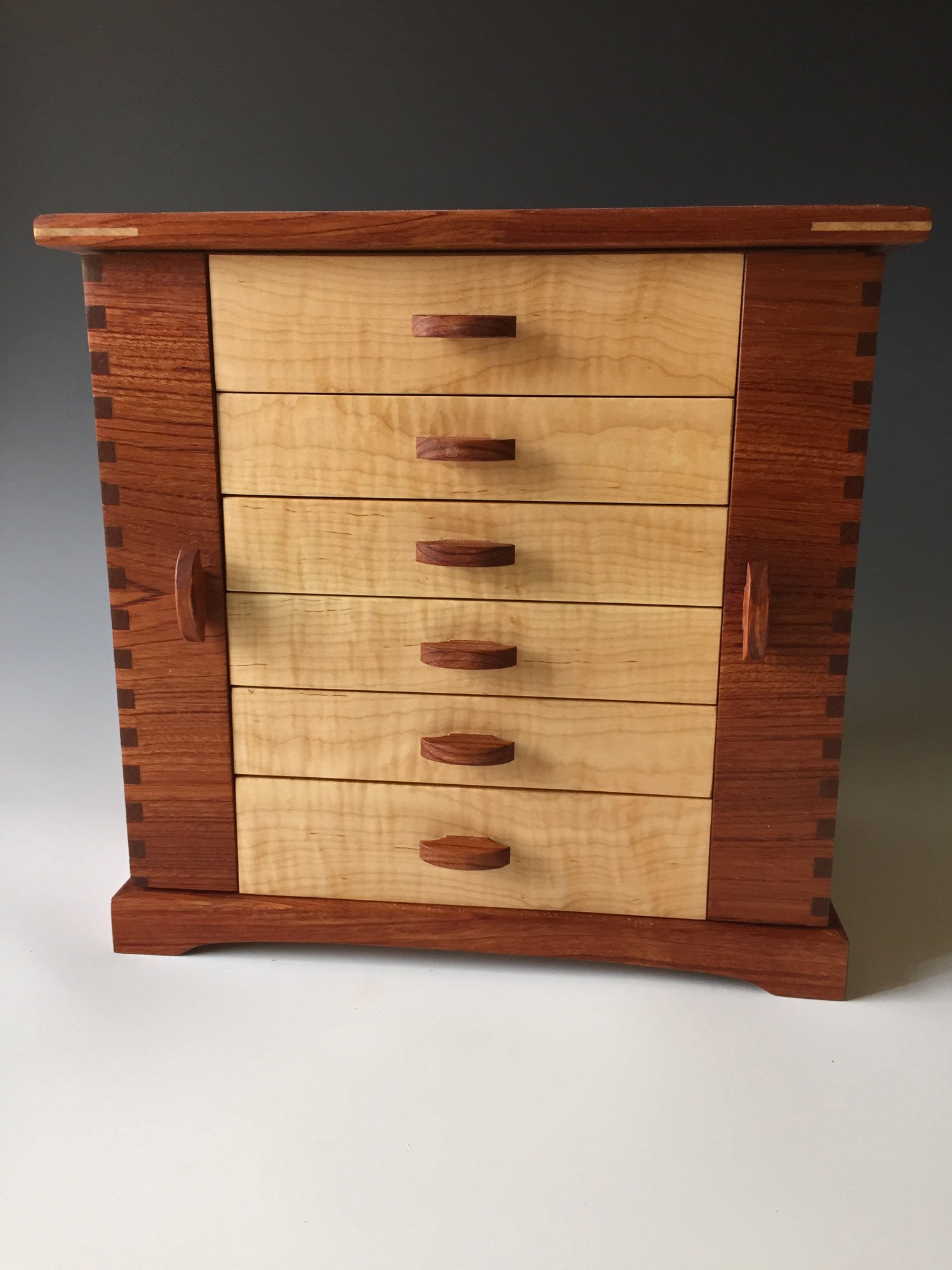 Another photo of a standing jewelry box shown in bubinga, a red wood from Africa.